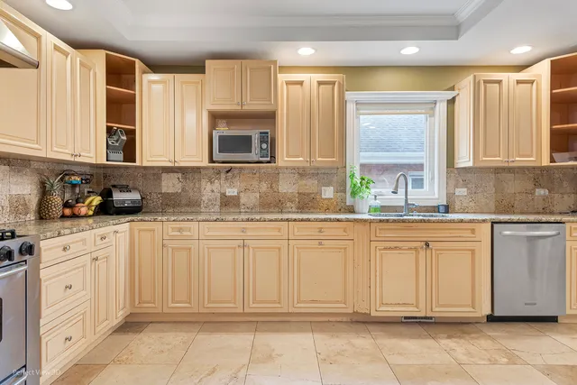 a kitchen with stainless steel appliances granite countertop a sink and cabinets