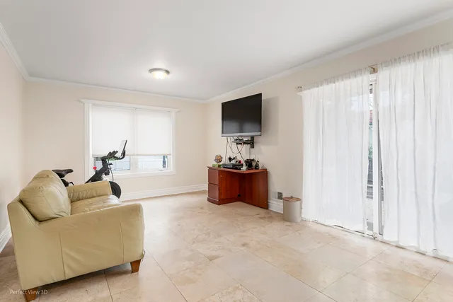 a living room with furniture a flat screen tv and a window