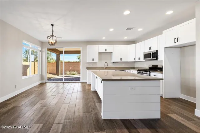 a kitchen with stainless steel appliances granite countertop a stove and a refrigerator