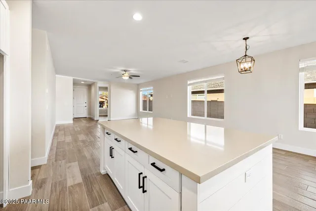 a spacious bathroom with a granite countertop sink window and a large mirror