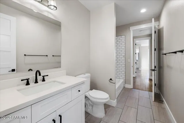 a bathroom with a sink a toilet a shower and a mirror