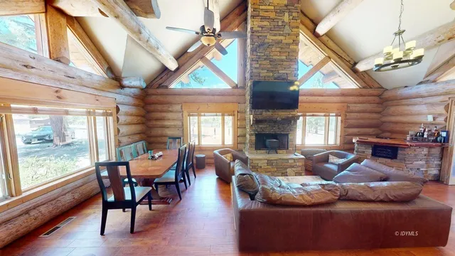 a living room with furniture a fireplace and wooden floor
