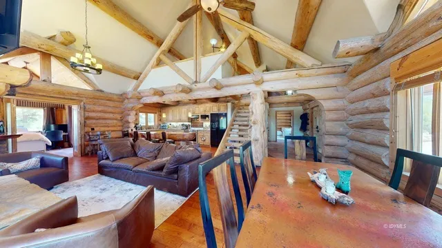 a dining room with wooden floors table and chairs