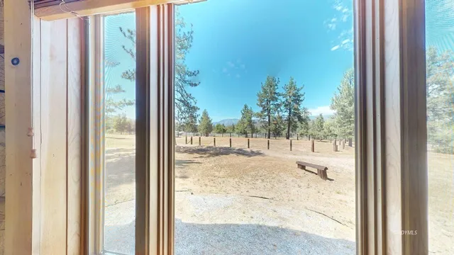 a bedroom with a bed and a large window with balcony view