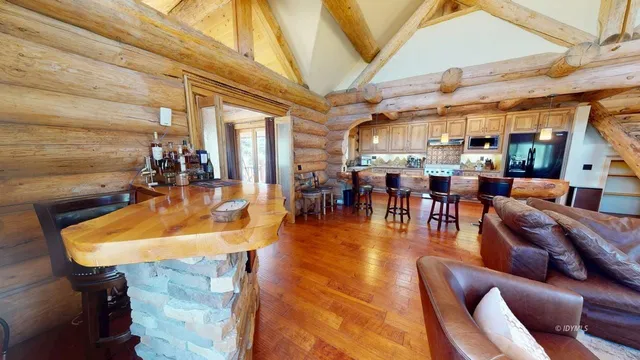 a living room with a large window and a bed