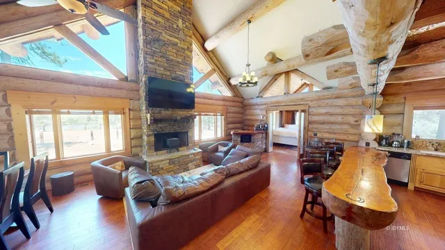 a living room with fireplace furniture and a large window