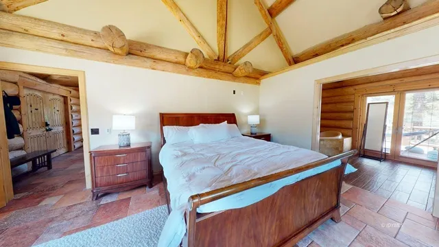 a view of a room with lots of wooden furniture and a fireplace