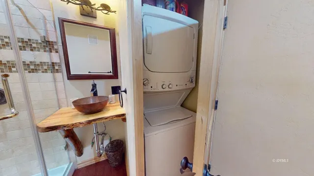 a view of a backyard with table and chairs couches under an umbrella