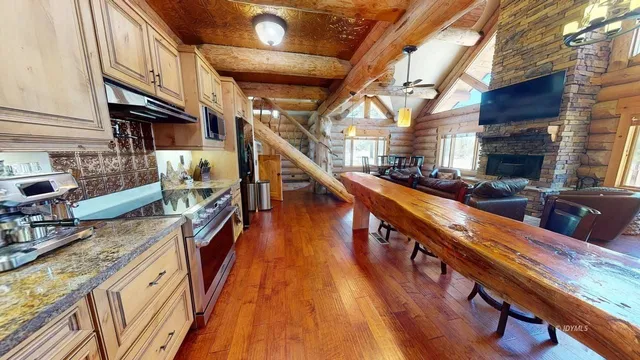 a kitchen with stainless steel appliances granite countertop a stove and a microwave