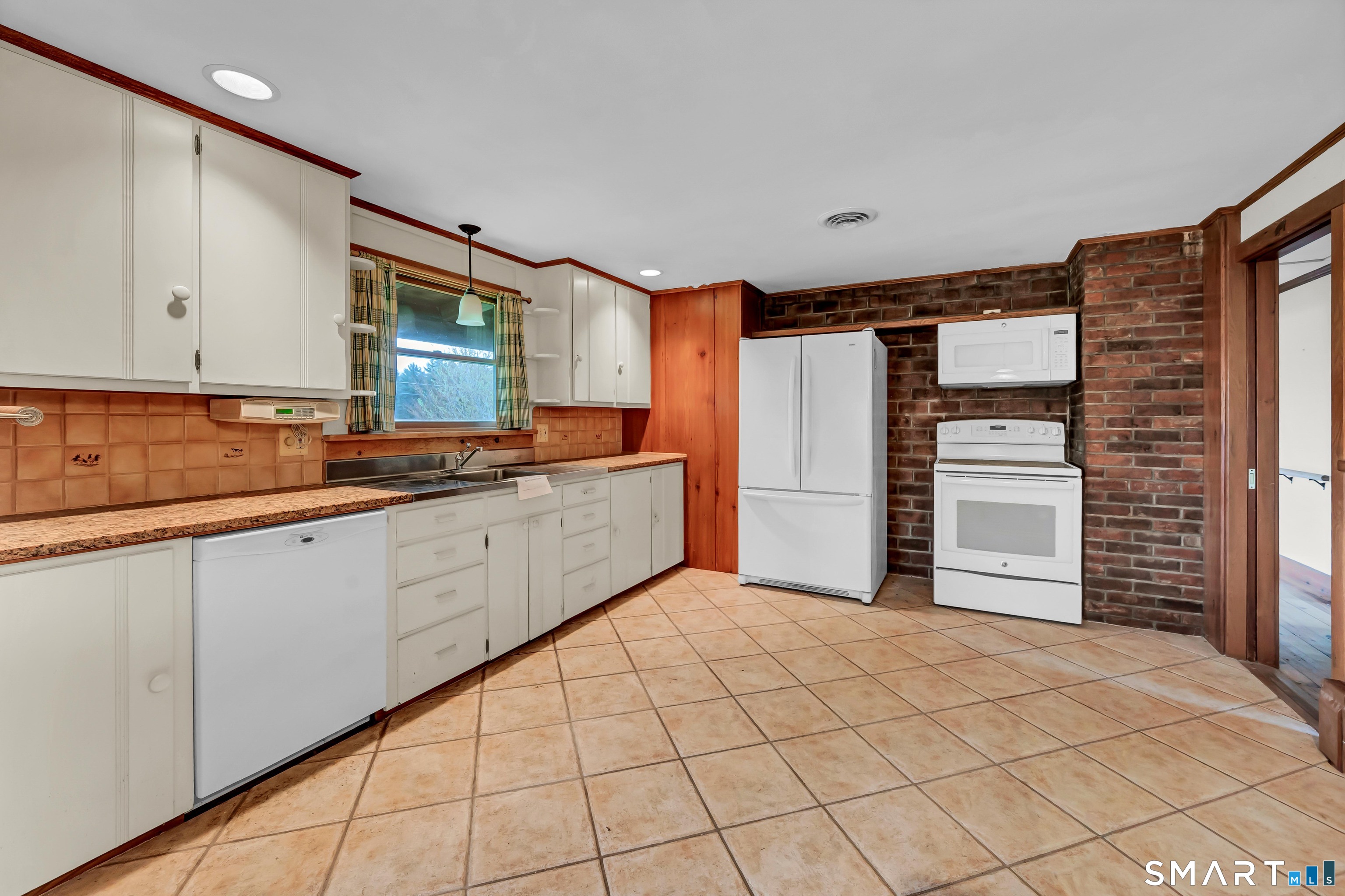 139 West Side Road Goshen, CT 06756 - Photo 6 of 17 a kitchen with stainless steel appliances kitchen island sink refrigerator and cabinets