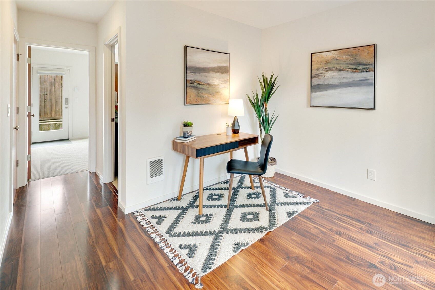 14308 Midvale Avenue North Seattle, WA 98133 - Photo 22 of 29 a view of a hallway with wooden floor and a workspace
