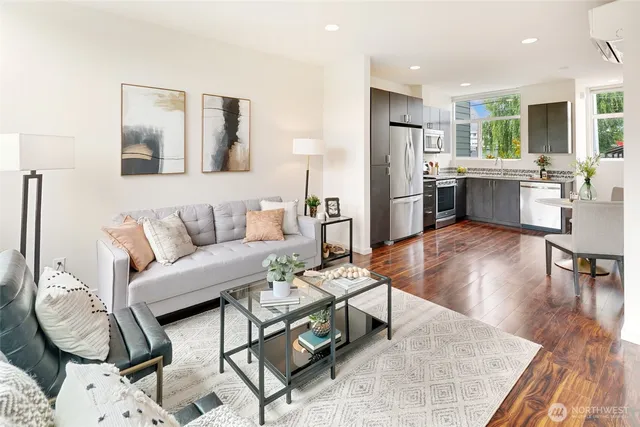 a living room with furniture and kitchen view