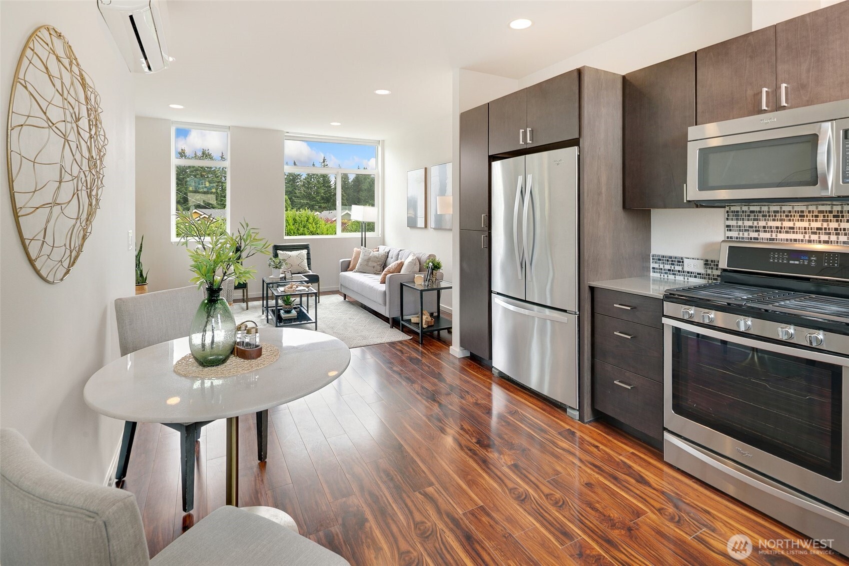 14308 Midvale Avenue North Seattle, WA 98133 - Photo 9 of 29 a kitchen with stainless steel appliances granite countertop a refrigerator a stove a sink dishwasher a dining table and chairs with wooden floor