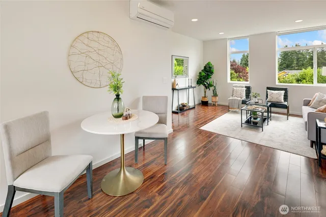 a living room with furniture a table and wooden floor