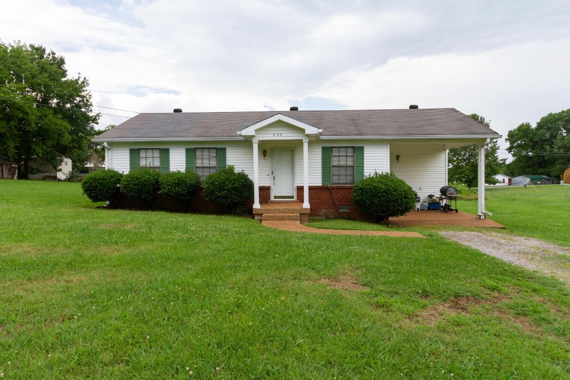 256 Atkinson Road Lebanon, TN 37090 - Photo 1 of 34 a front view of a house with a yard and green space