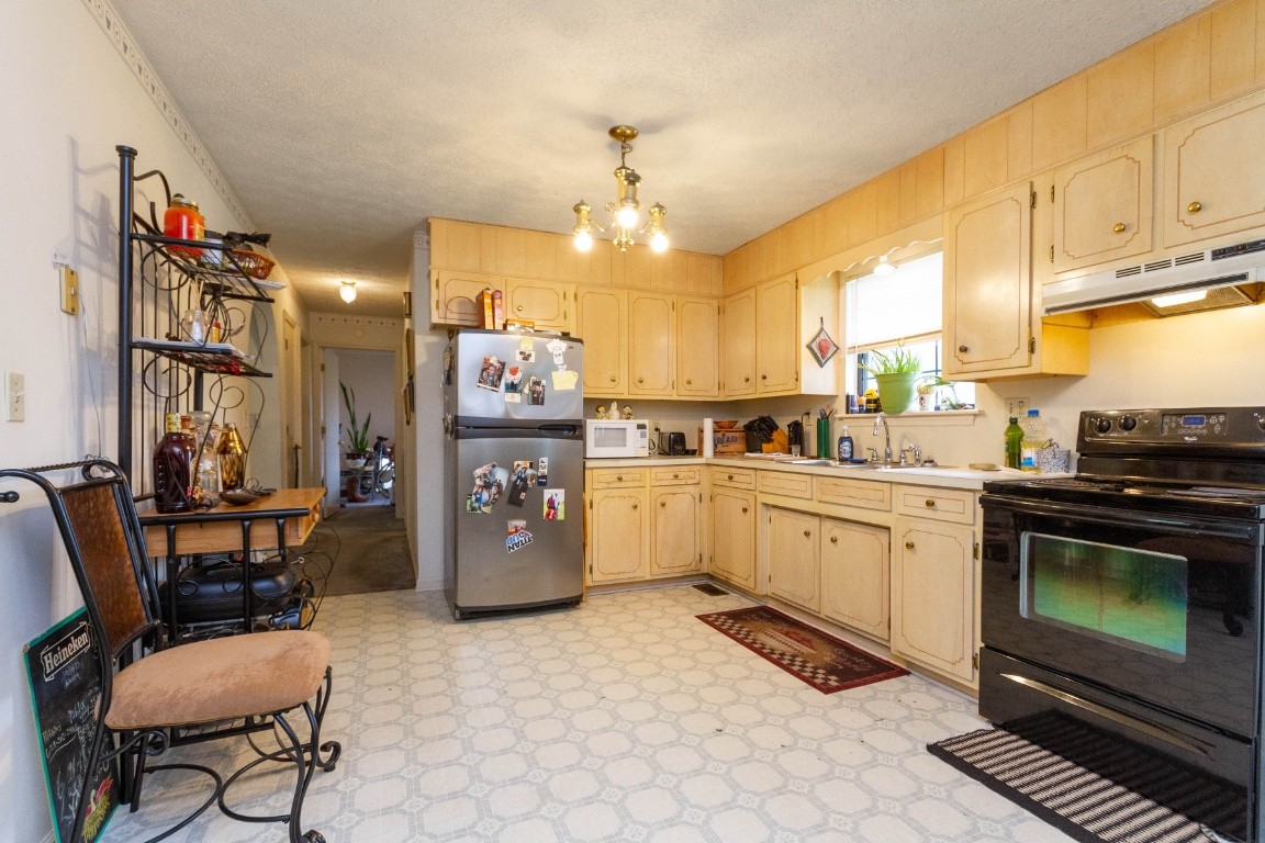 256 Atkinson Road Lebanon, TN 37090 - Photo 11 of 34 a kitchen with a refrigerator and a stove top oven