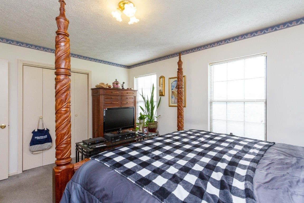 256 Atkinson Road Lebanon, TN 37090 - Photo 20 of 34 a bedroom with a bed dresser and a flat tv screen