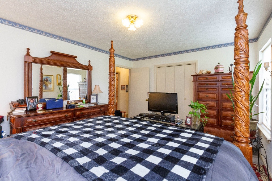 256 Atkinson Road Lebanon, TN 37090 - Photo 21 of 34 a bedroom with a bed dresser and a flat screen tv