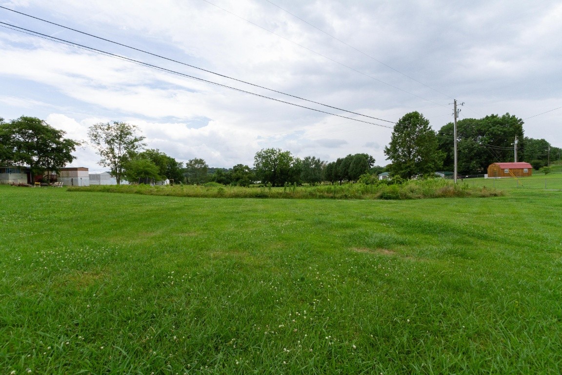 256 Atkinson Road Lebanon, TN 37090 - Photo 30 of 34 a backyard of a house with lots of green space and lake view