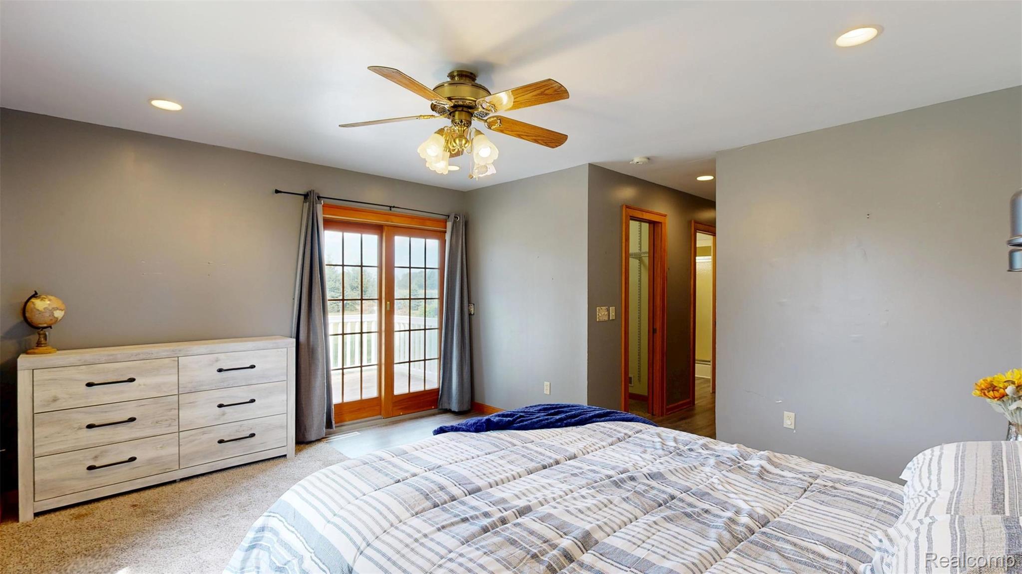 12930 Wilkinson Road Freeland, MI 48623 - Photo 58 of 76 Recessed ceiling lighting, a ceiling fan with light fixture, light wood-finish sliding glass doors, and light wood-finish interior doors