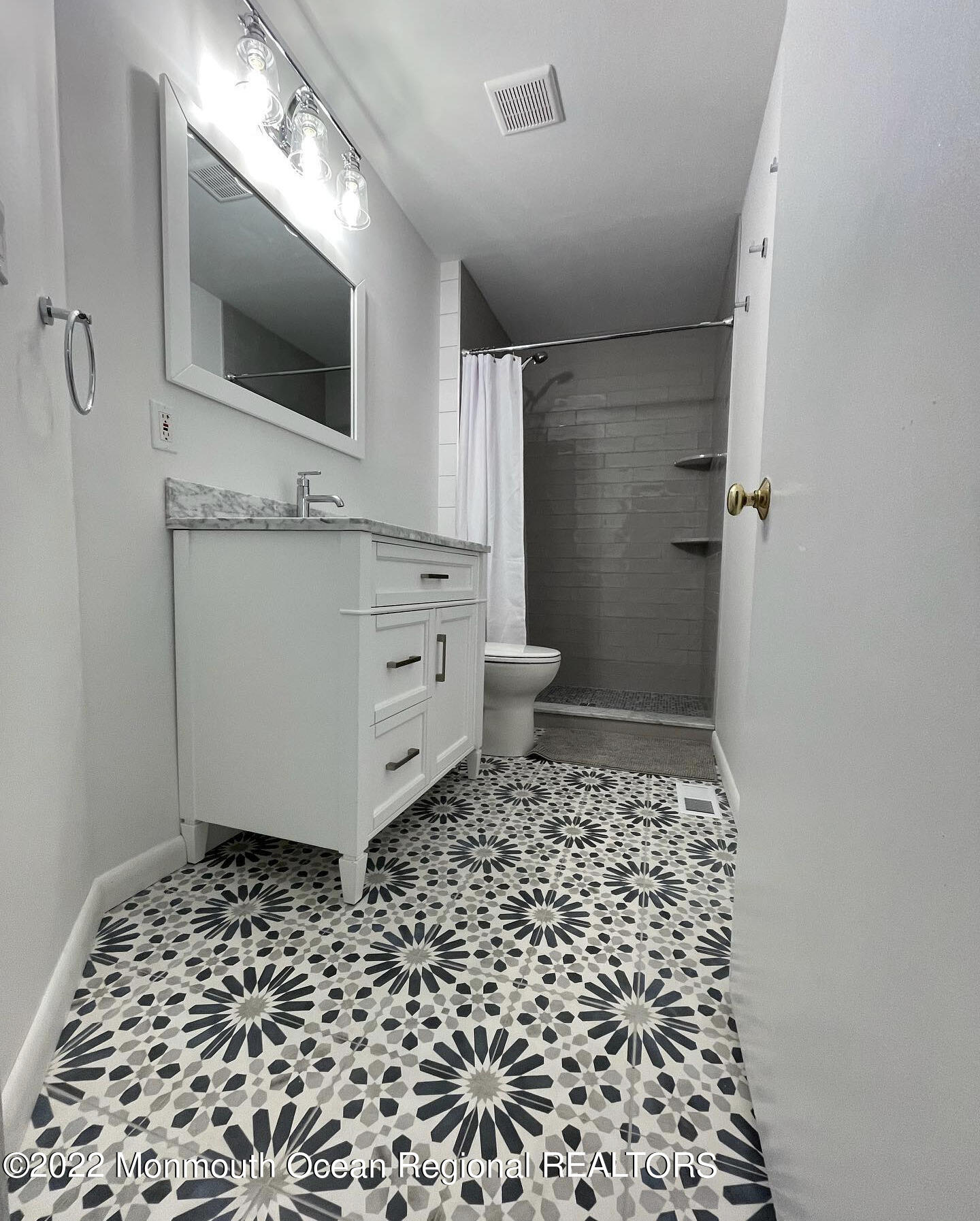 1703 A Street, Unit REAR Belmar, NJ 07719 - Photo 12 of 29 a bathroom with a sink a toilet and a shower