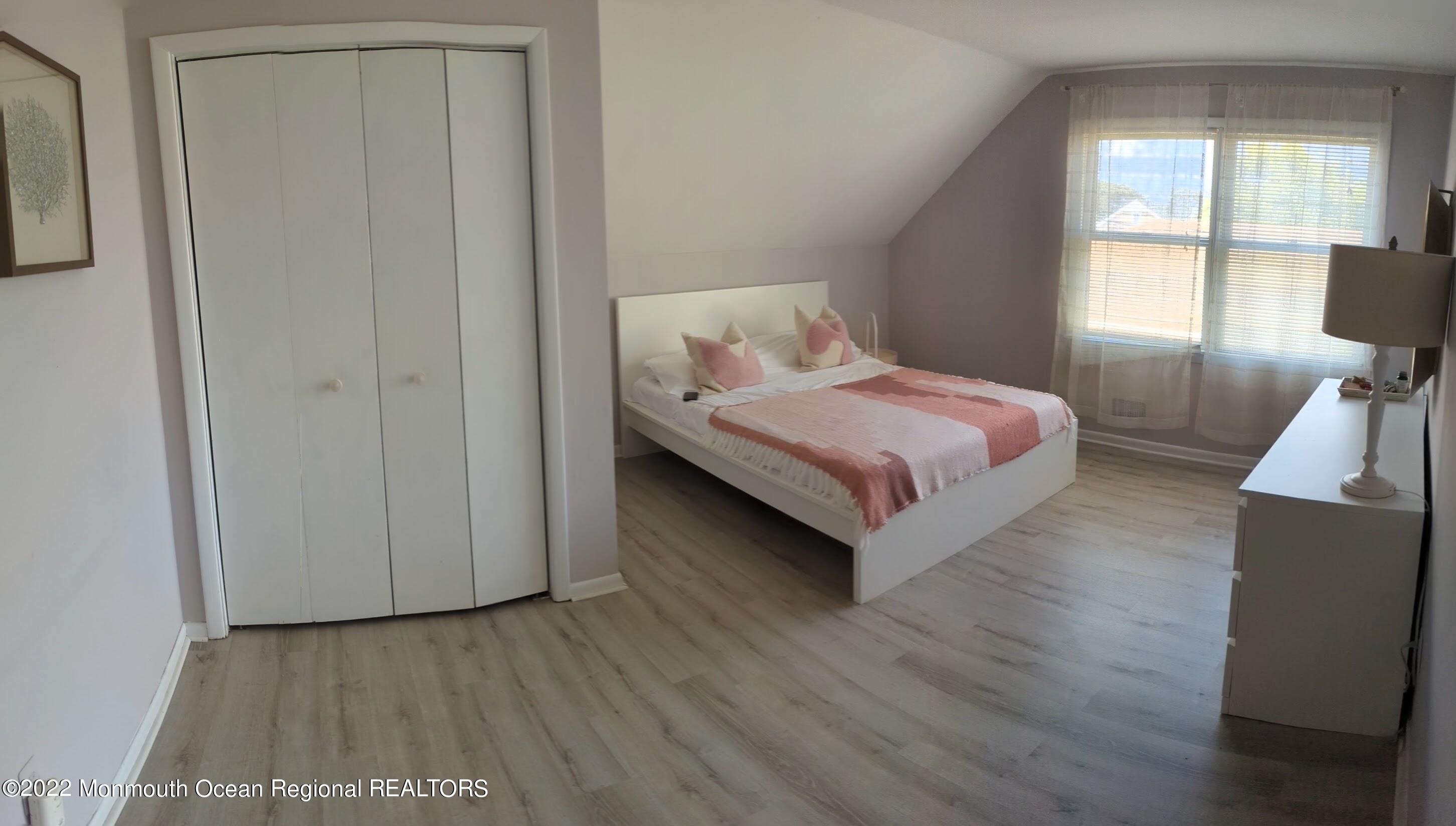 1703 A Street, Unit REAR Belmar, NJ 07719 - Photo 14 of 29 a bedroom with a bed and window