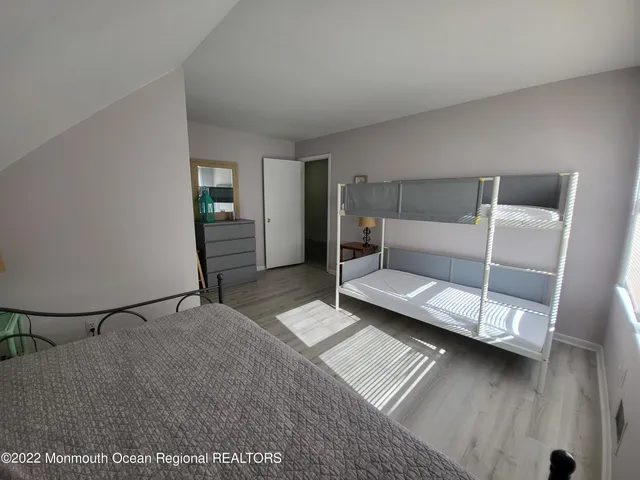 a bedroom with furniture and a ceiling fan