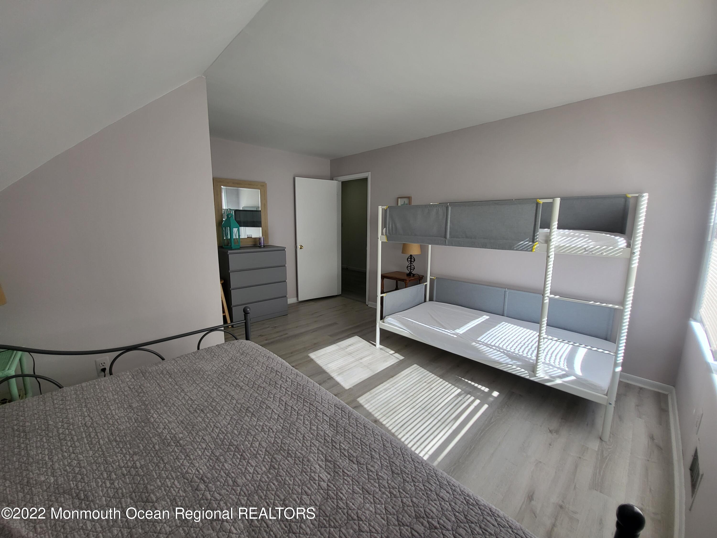 1703 A Street, Unit REAR Belmar, NJ 07719 - Photo 17 of 29 a bedroom with furniture and a ceiling fan