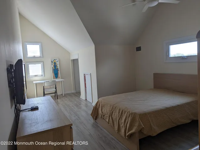 a bedroom with a bed a mirror on desk and a mirror