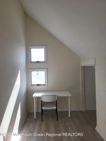 a view of a hallway with a window and a kitchen