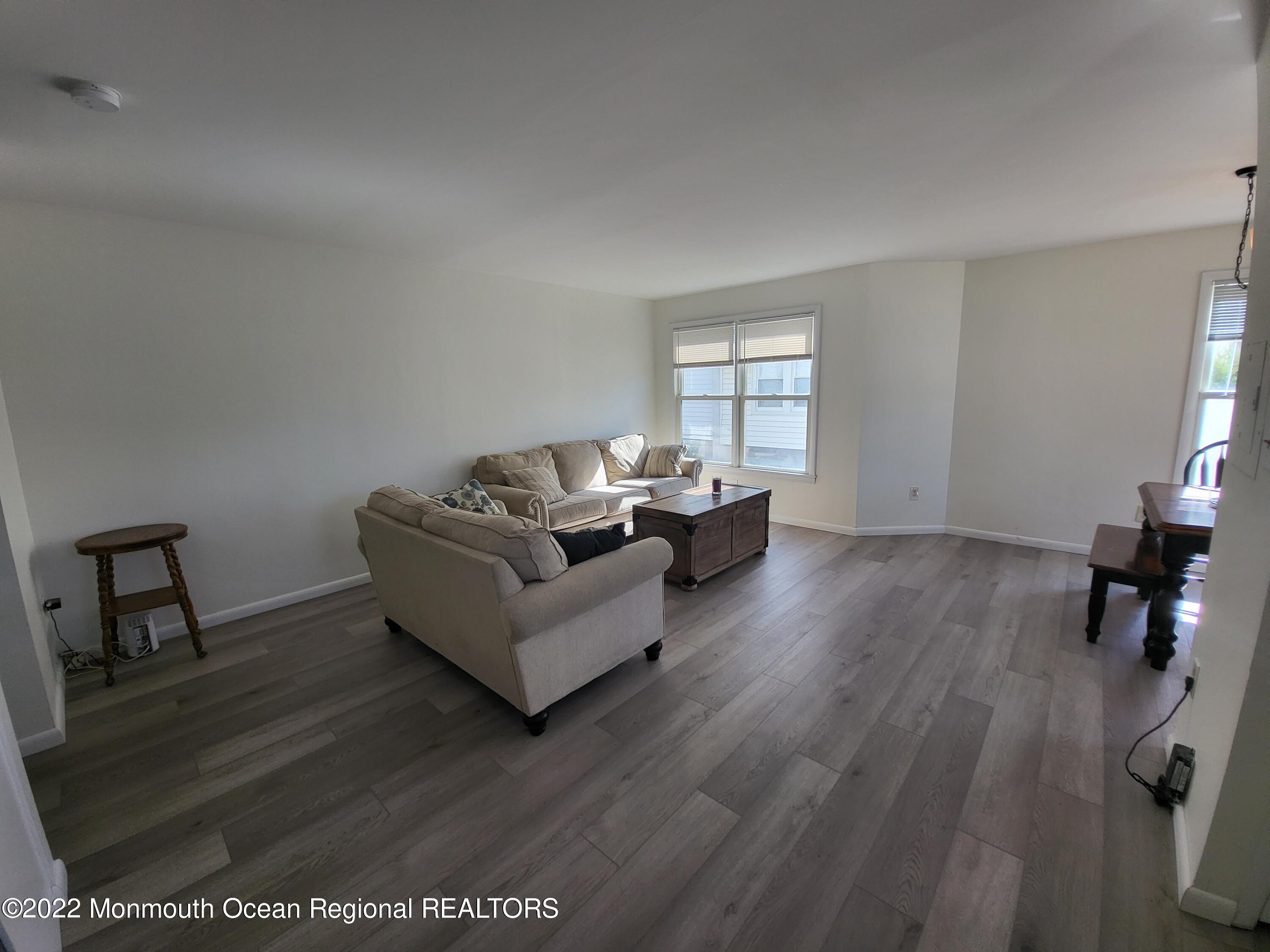 1703 A Street, Unit REAR Belmar, NJ 07719 - Photo 5 of 29 a living room with furniture and a wooden floor