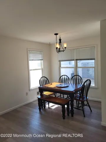 a dining room with furniture a rug and wooden floor