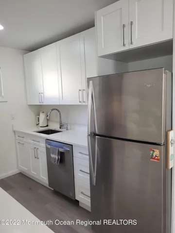 a white refrigerator freezer sitting inside of a kitchen