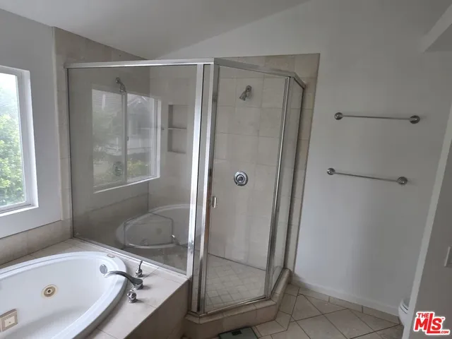 a bathroom with a tub and a shower