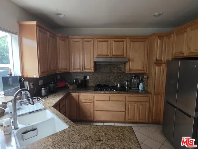 a kitchen with a sink stove and refrigerator