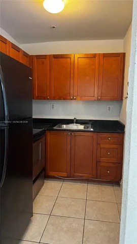 a kitchen with a sink a stove and cabinets