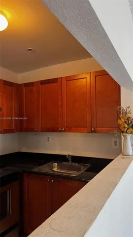 a kitchen with a sink and cabinets
