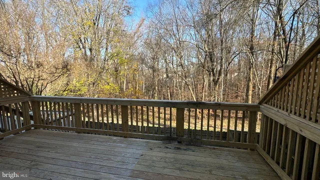 a balcony with wooden floor and fence