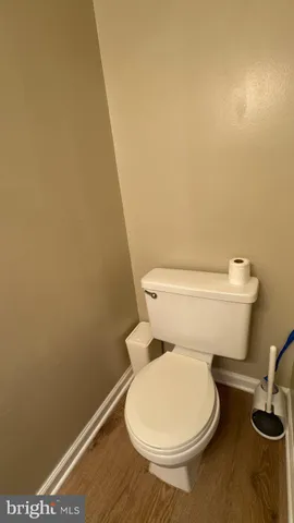 a white toilet sitting next to a sink
