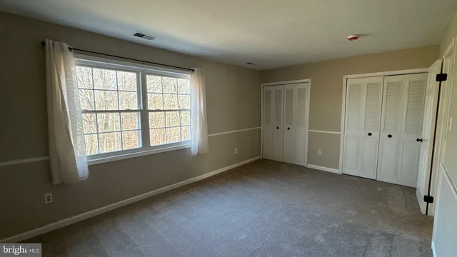 an empty room with a empty space and windows