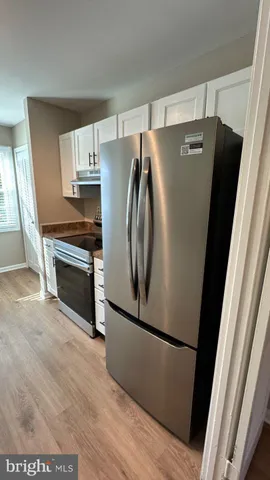 a view of cabinets and wooden floor