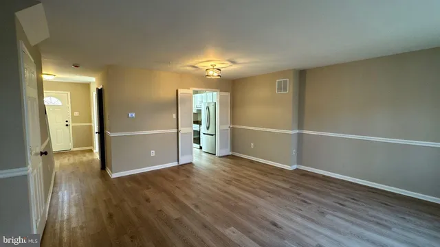 wooden floor in an empty room with a window