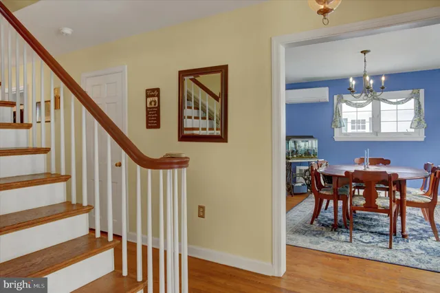 a dining room with furniture a rug and a chandelier