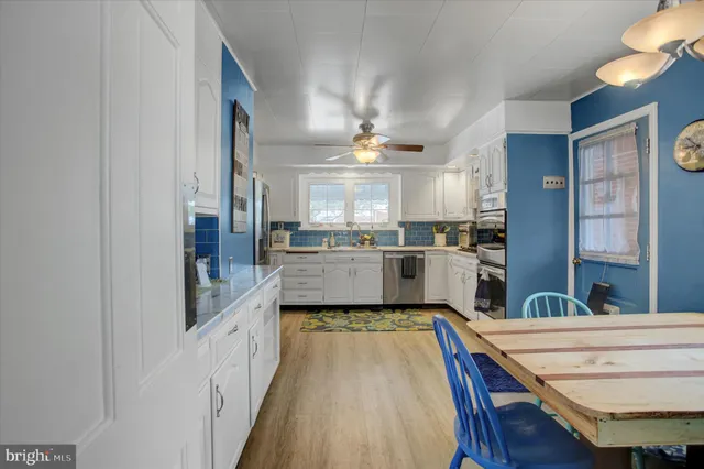 a view of a dining room with furniture and a window