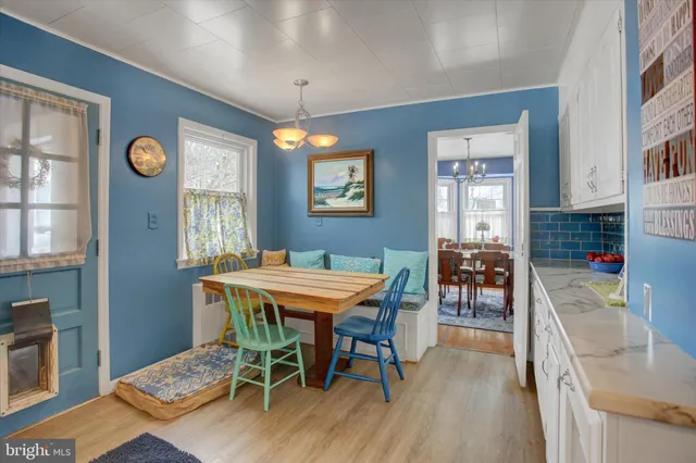 a kitchen with cabinets a window and stainless steel appliances