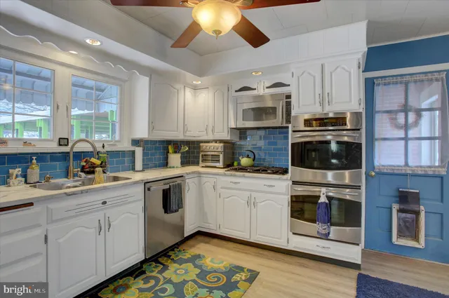a kitchen with stainless steel appliances a refrigerator and wooden cabinets