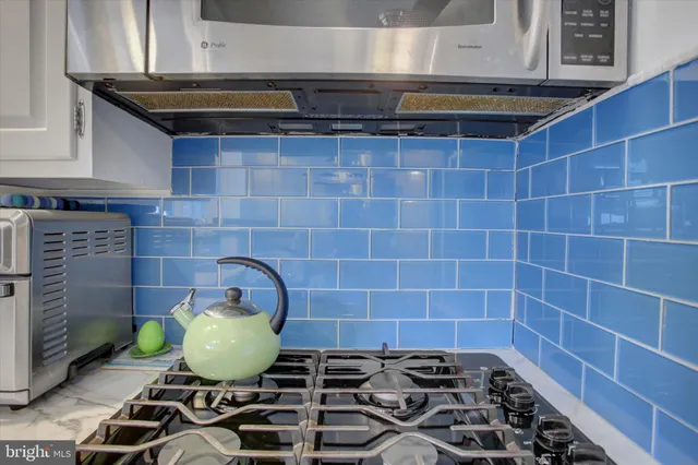 a bathroom with a sink a toilet and curtain