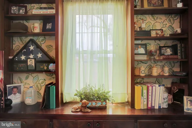 a bathroom with a sink toilet and a window