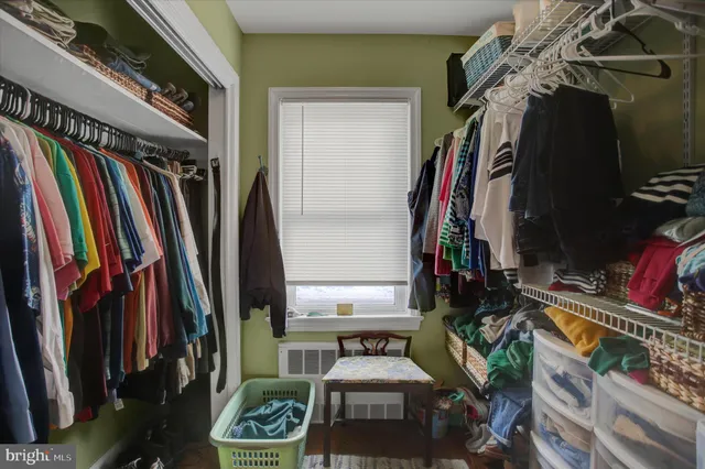 a bedroom with a bed window and a mirror