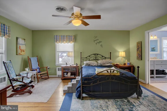 a bedroom with a bed dresser and a window